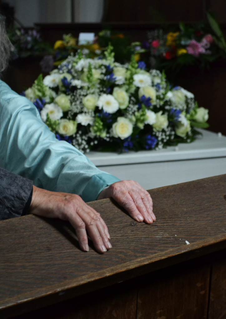 hands in front of coffin